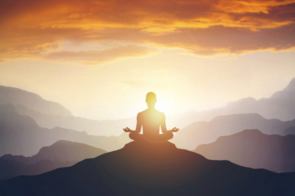 Man sitting at mountain doing meditation